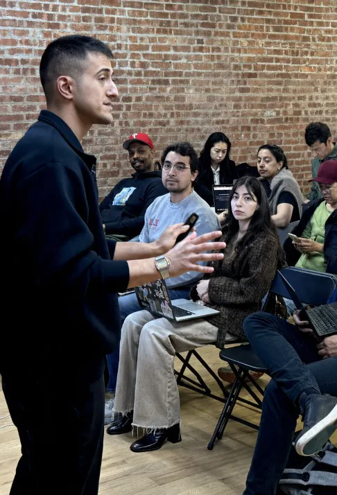 Matt Feroz speaking at a live AI event